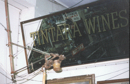 Tintara Wines advertising mirror with one of the cashier’s pulleys on display in the Kwong Sing store.